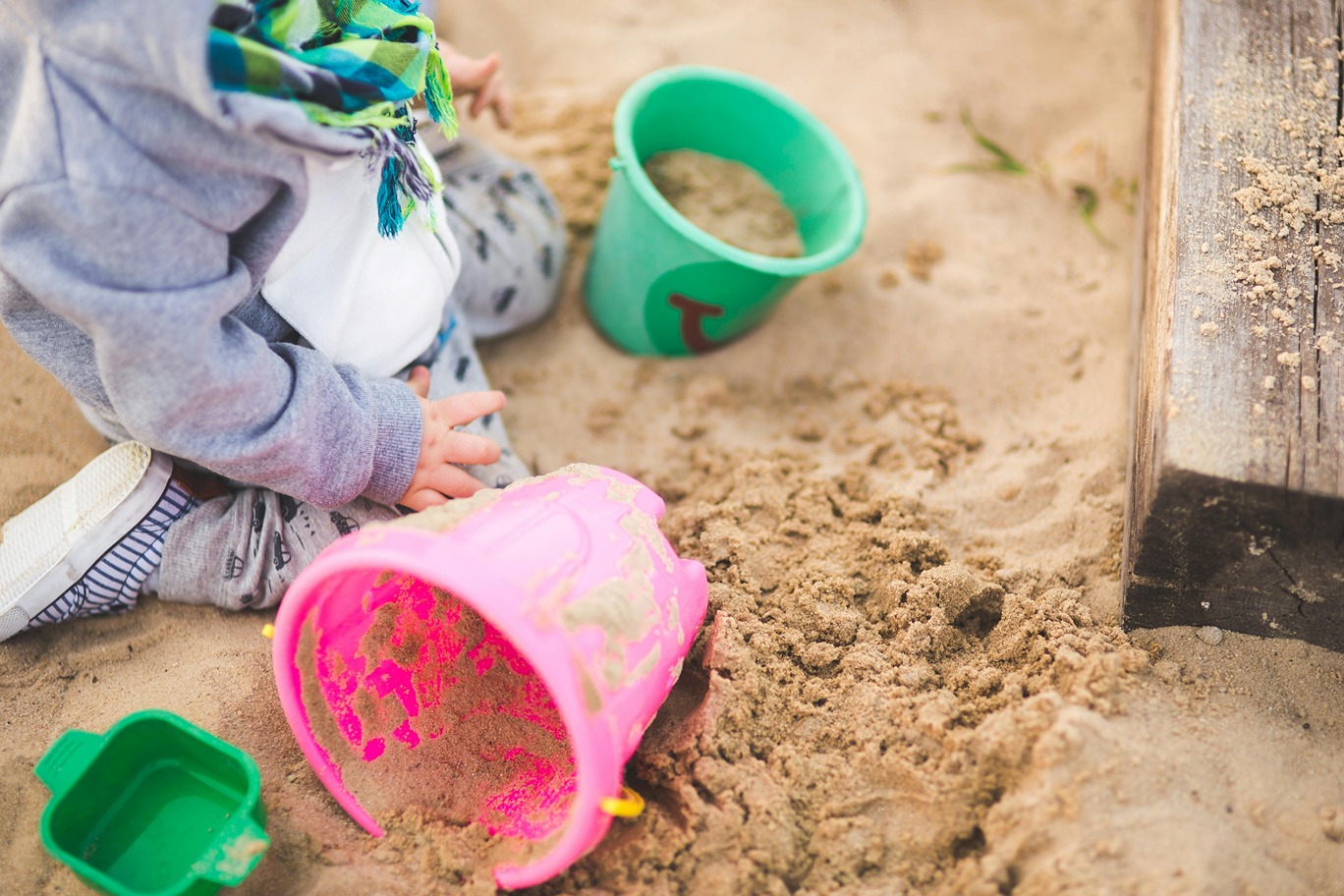 a small child playing in a sandbox