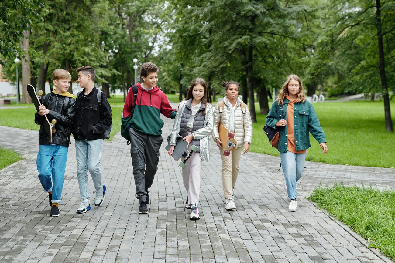 a group of six teens walking to school