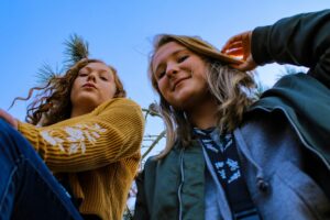 two teen girls looking down from above