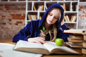 teen girl reading textbook